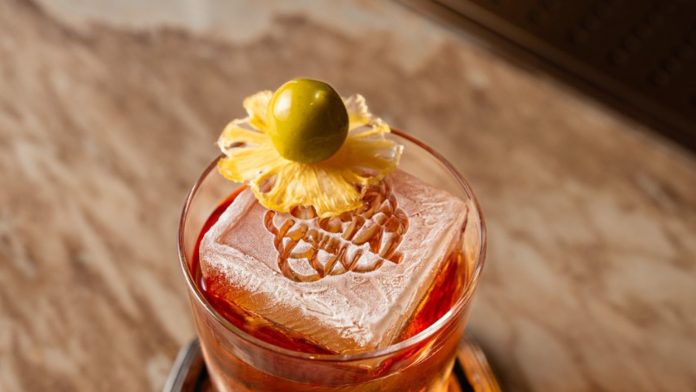 Cocktail with a sculpted ice block at BKK Social Club