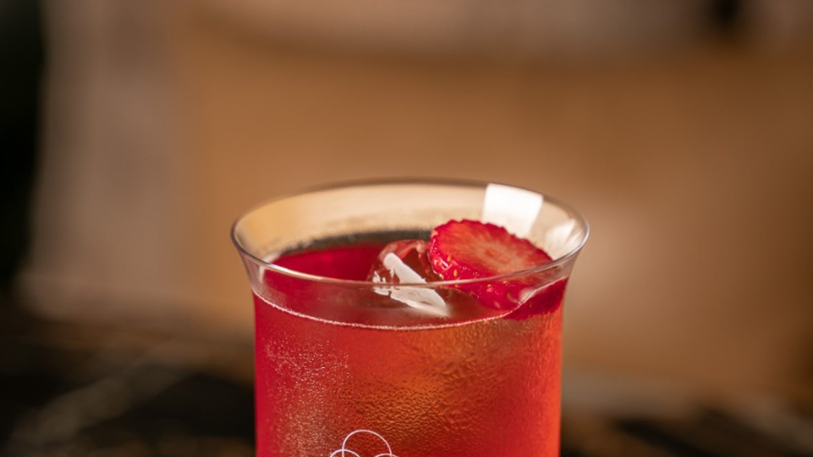 Red cocktail served over clear ice at BKK Social Club