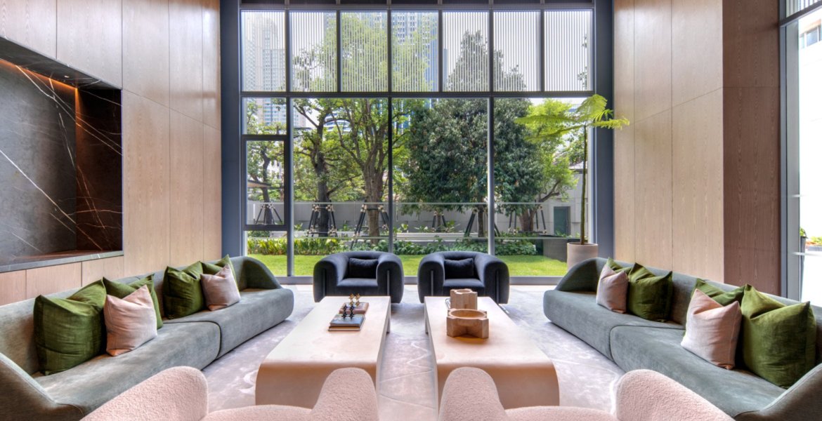 Bright living room with garden view at SCOPE Langsuan