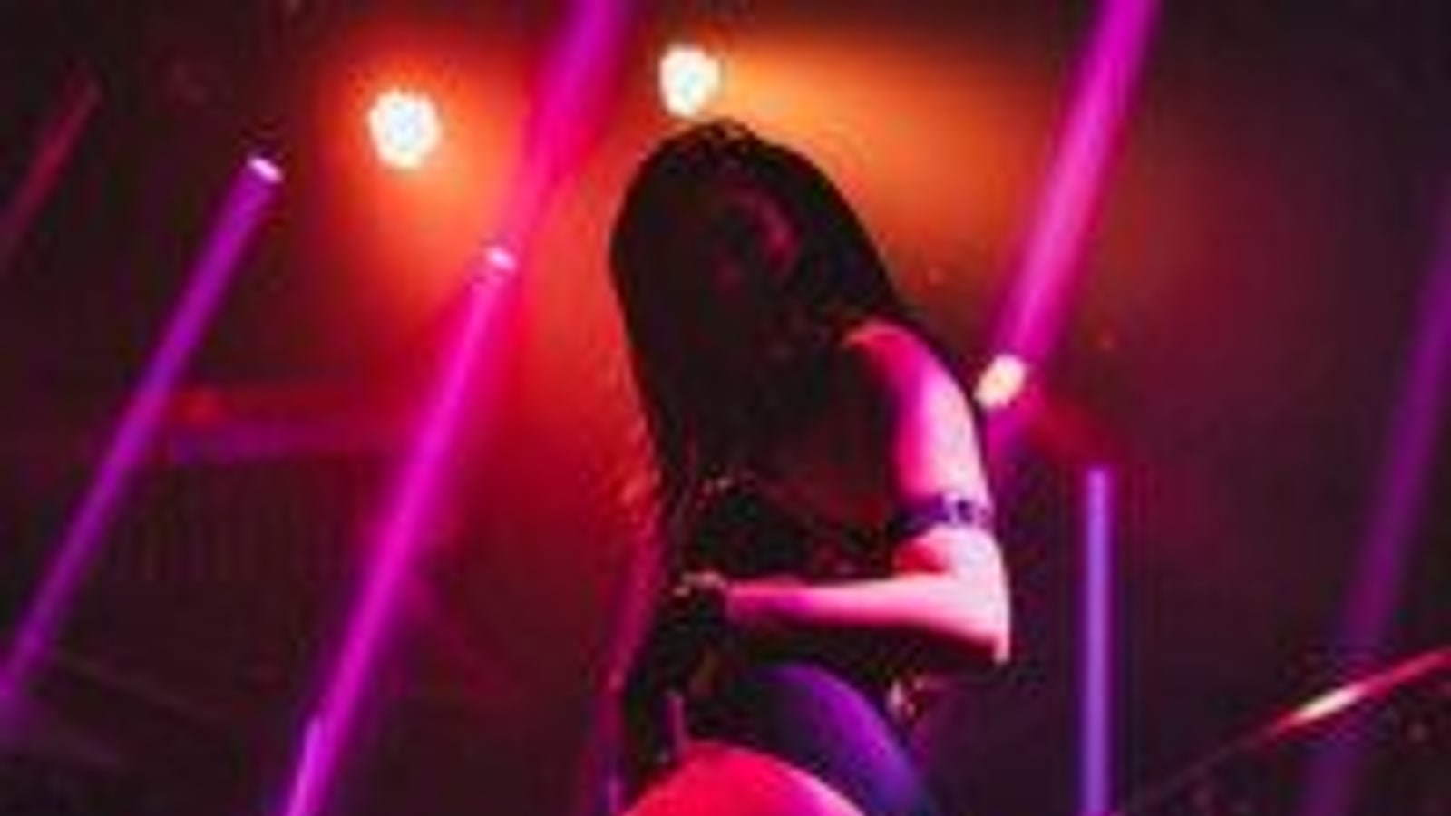 Performer under red and purple lighting at Levels Bangkok