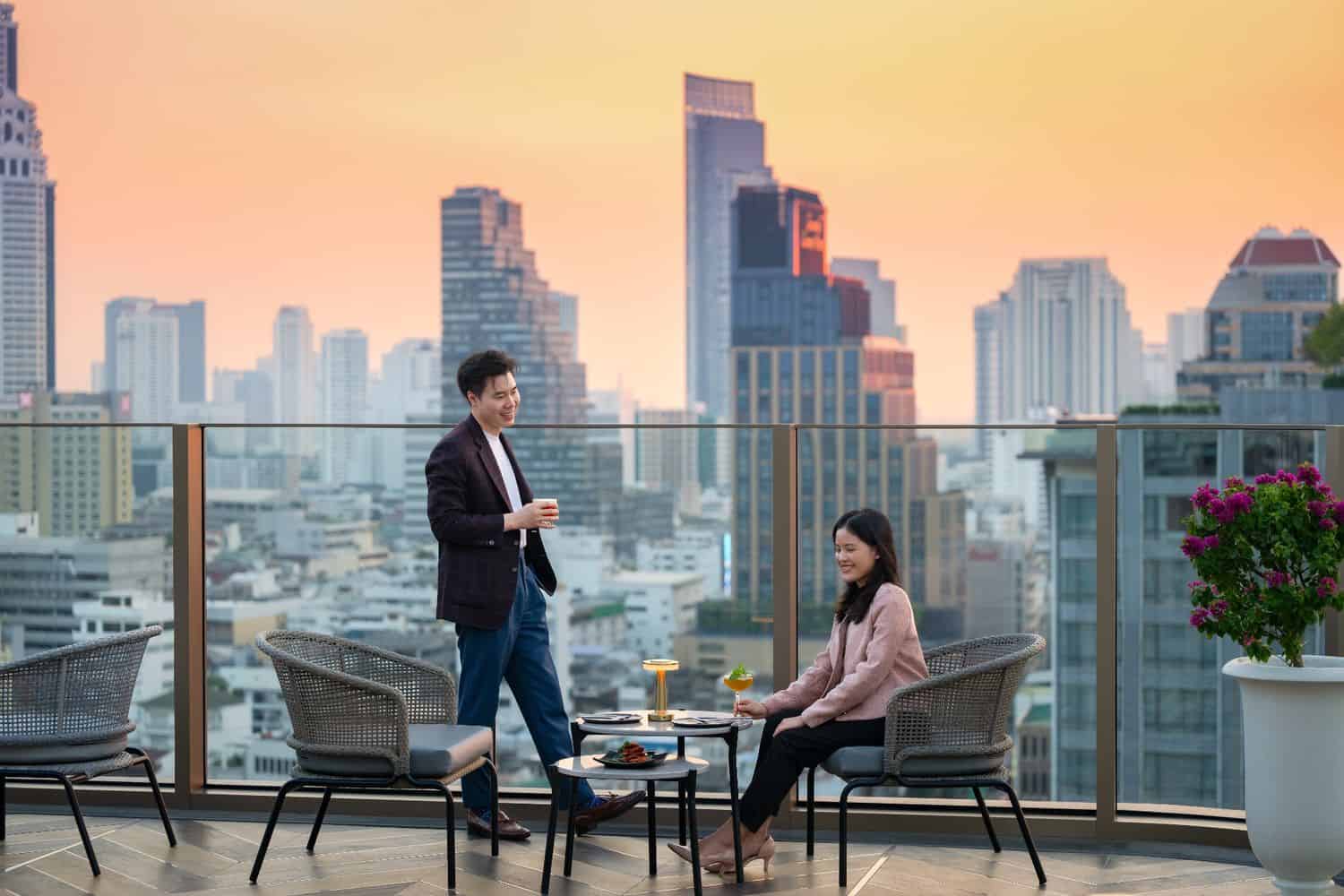 Outdoor terrace seating at Starlight Rooftop Bar during sunset