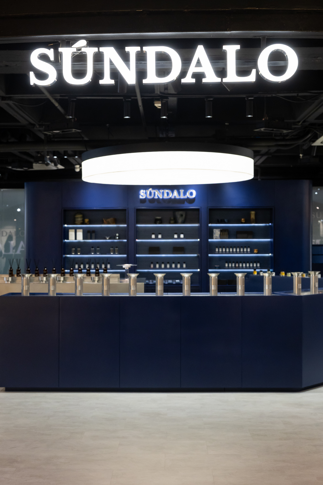 Dark perfume shelves inside SÚNDALO at Siam Center