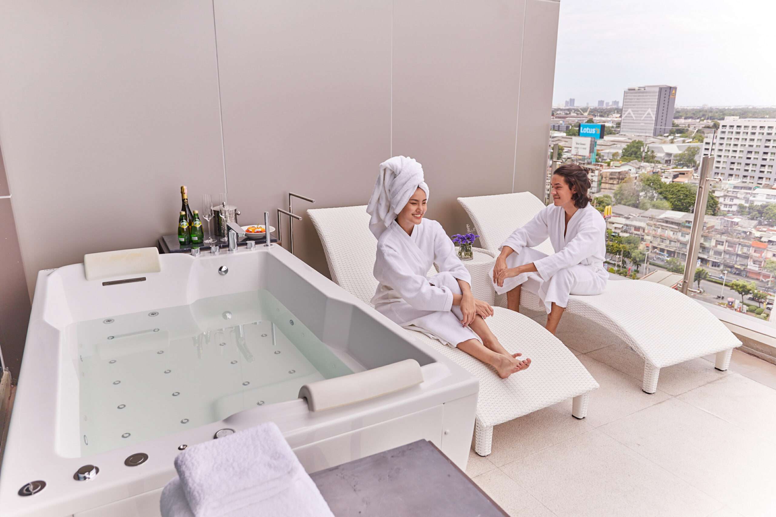 Guests enjoying an in-room jacuzzi with Bangkok views at Valia Hotel