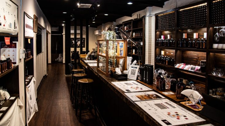 Coffee bar and retail shelves at Y'EST WORKS Asok