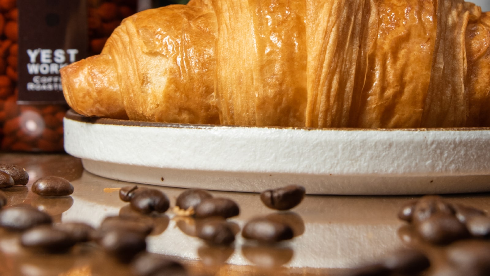Croissant served with coffee beans at Y'EST WORKS